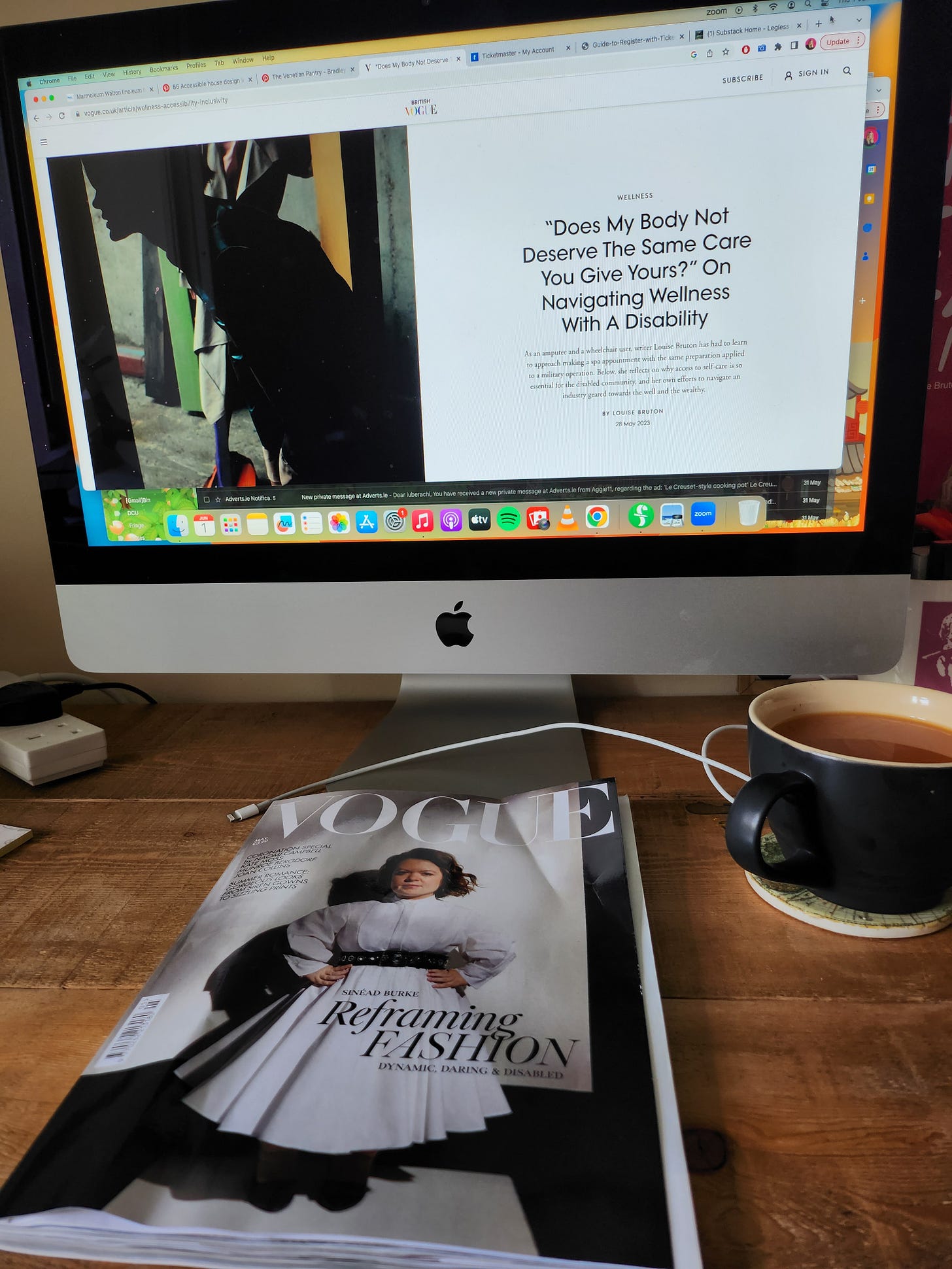 A desktop computer shows the article I wrote for vogue.co.uk, while the copy of Vogue with Sinead Burke on the cover sits below