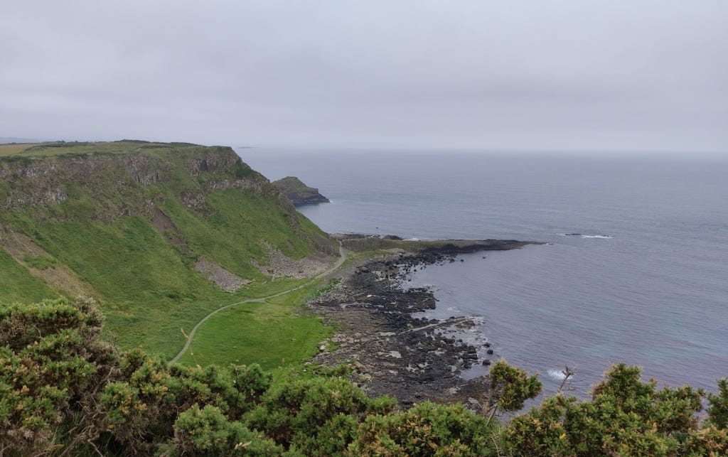Coastal view, green cliff slopes below