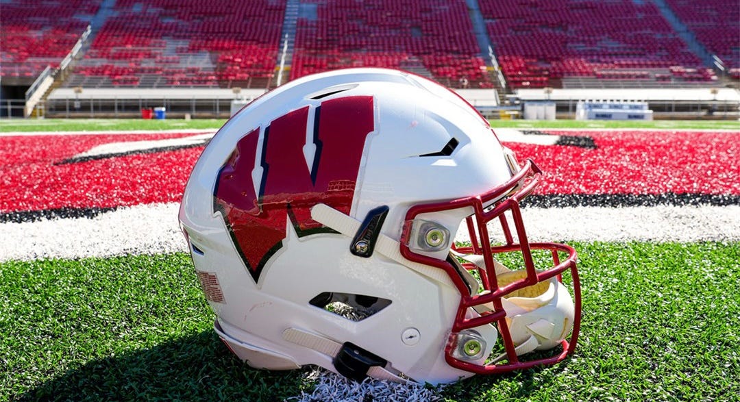 Wisconsin Badgers football helmet lying on the field at Camp Randall Stadium. Wisconsin Badgers football helmet lying on the field at Camp Randall Stadium.