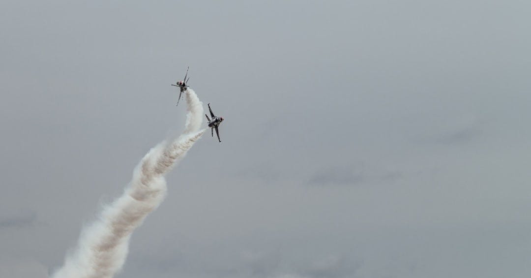 Jets perform an aerial stunt, leaving a vapor trail. Jets perform an aerial stunt, leaving a vapor trail.