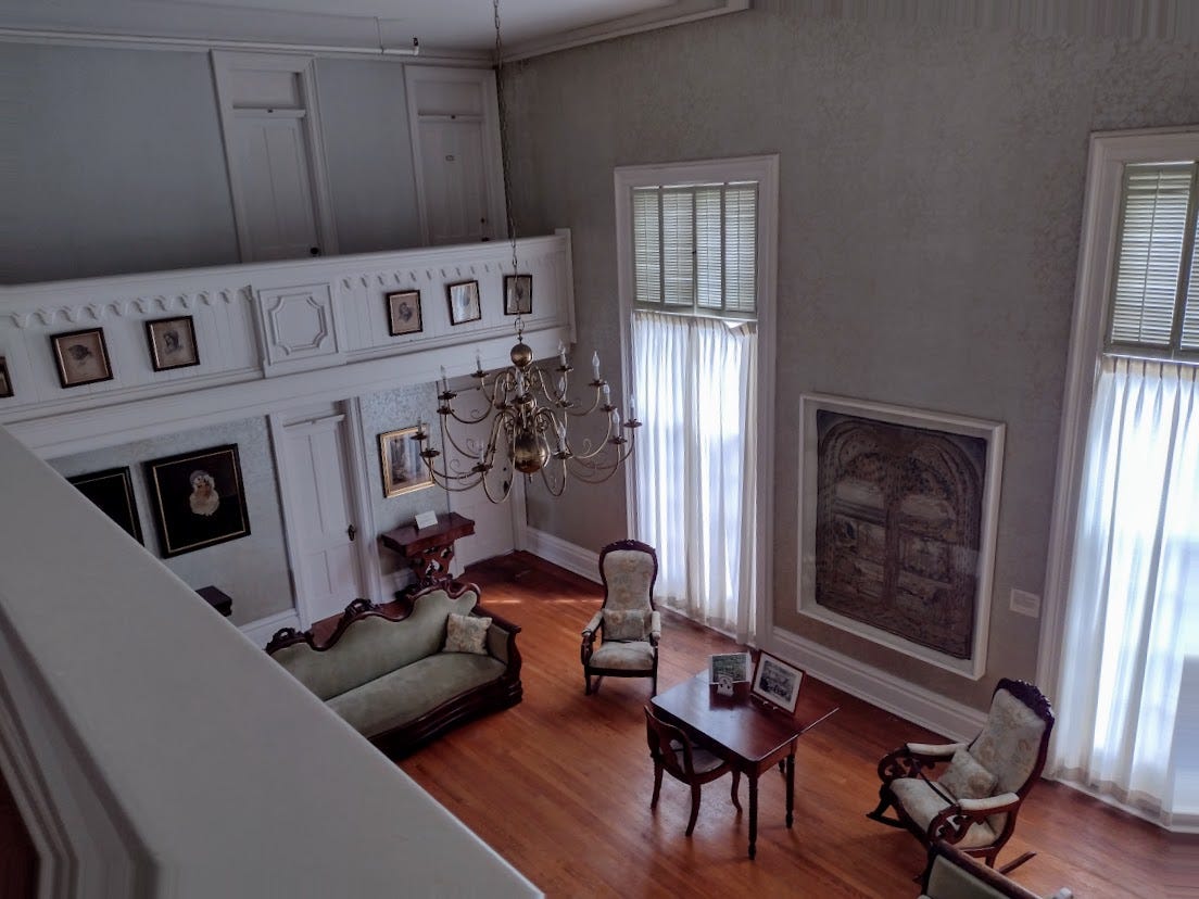 Large, two story room with sofa and other furniture