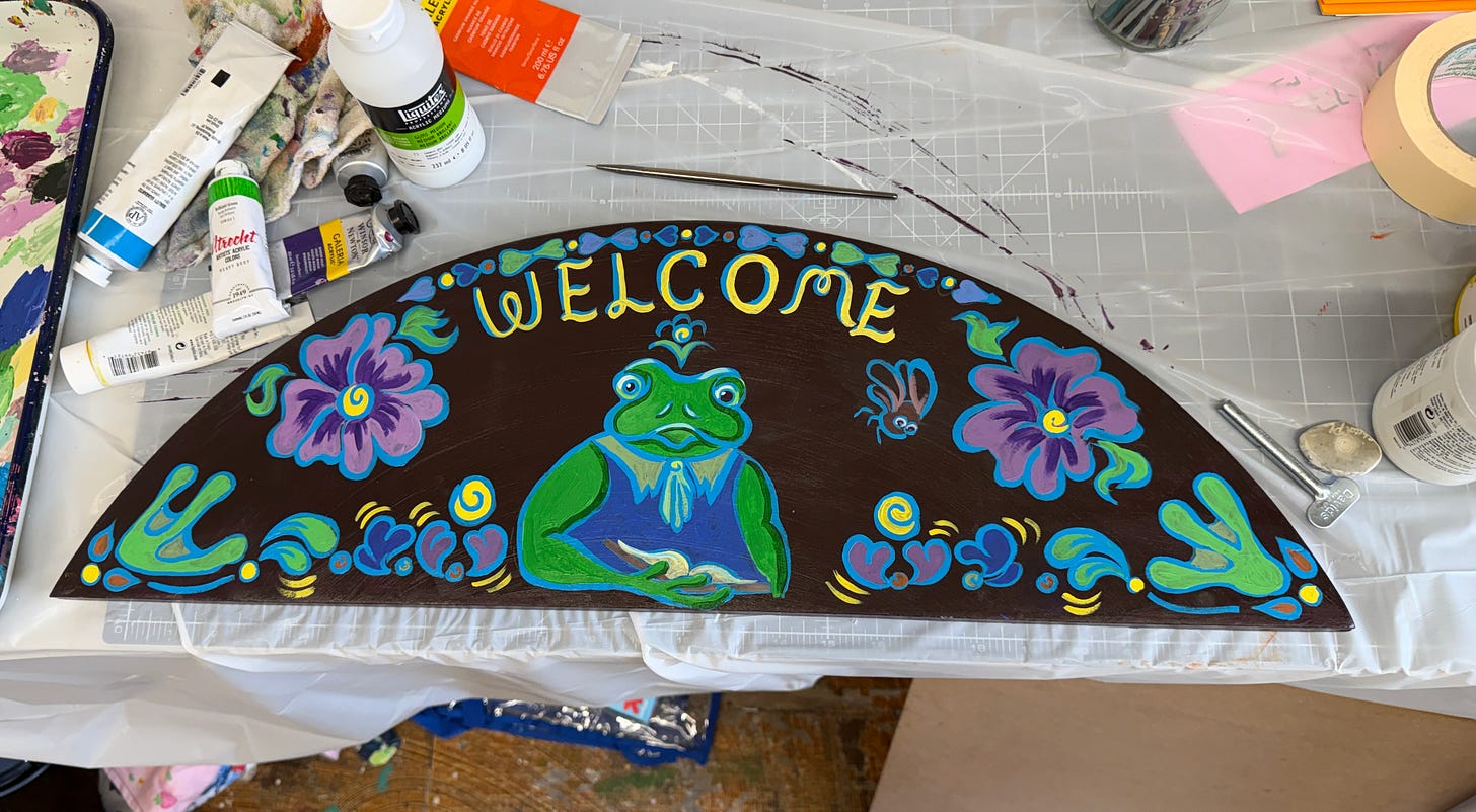 hand painted welcome sign with a frog center. hand painted welcome sign with a frog center.
