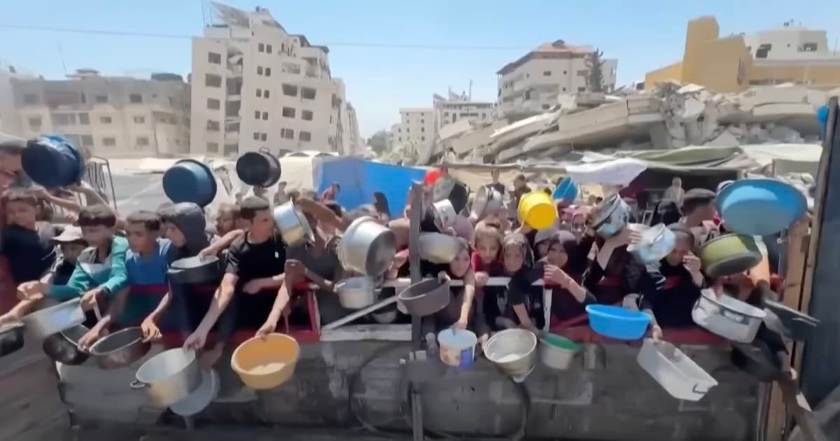 Food queue of starving Palestinians in Gaza due to Israel's blockade of aid trucks.