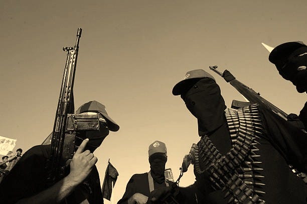 Masked Palestinian militants of the Democratic Front for the Liberation of Palestine celebrate at a rally in the former Jewish settlement of Neve...