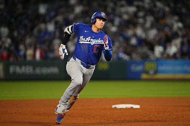 Shohei Ohtani of the Los Angeles Dodgers rounds the bases after hitting a home run during the game between the Los Angeles Dodgers and the Los...