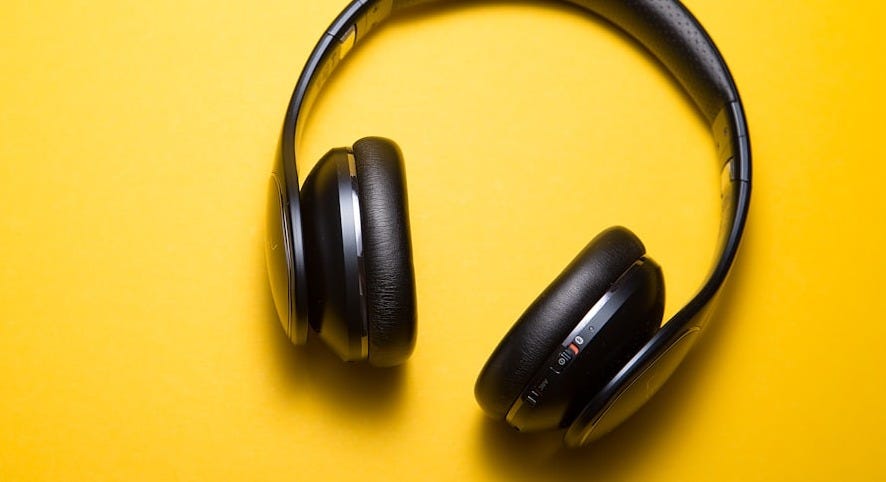 flatlay photography of wireless headphones