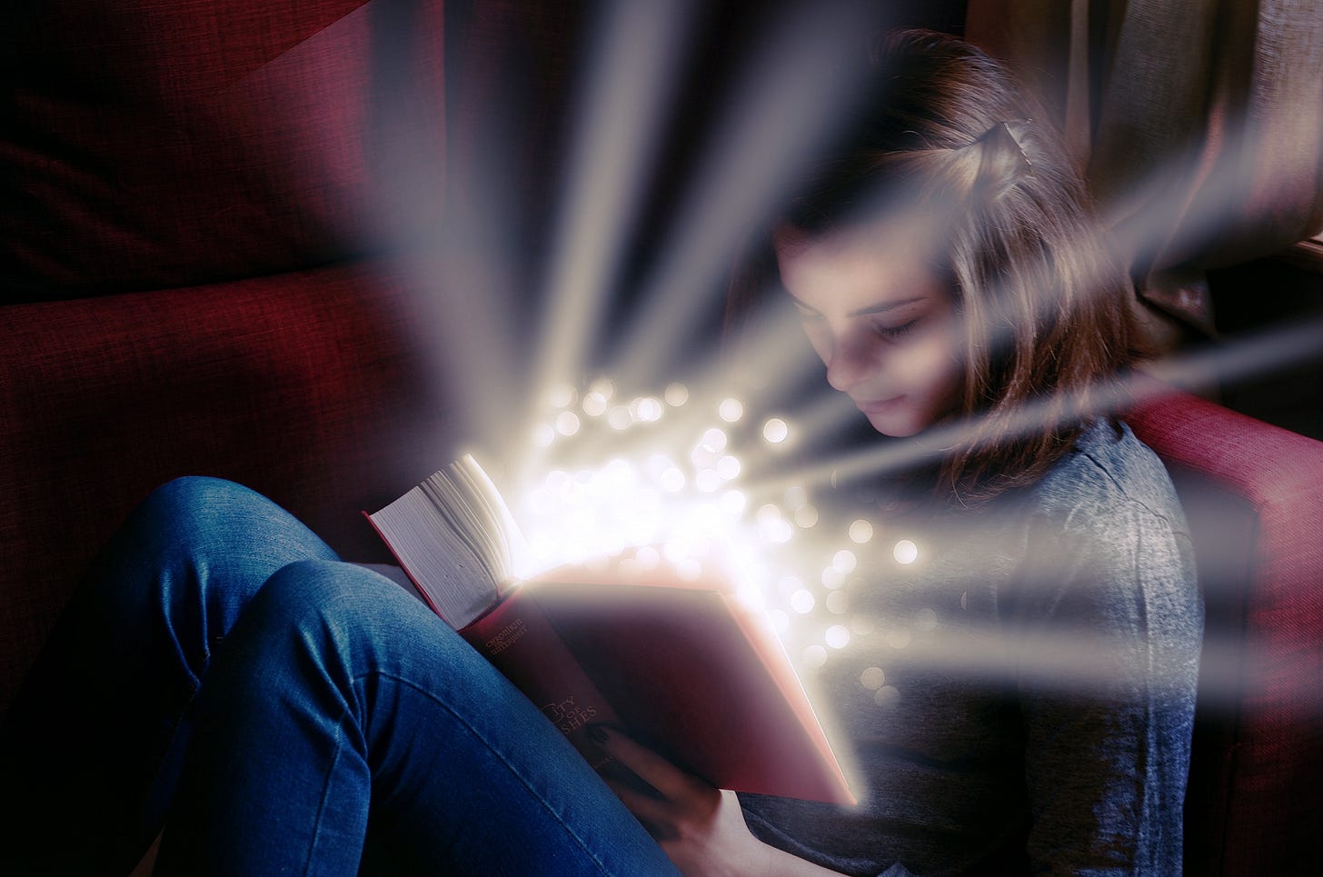 A girl reading a magical book.