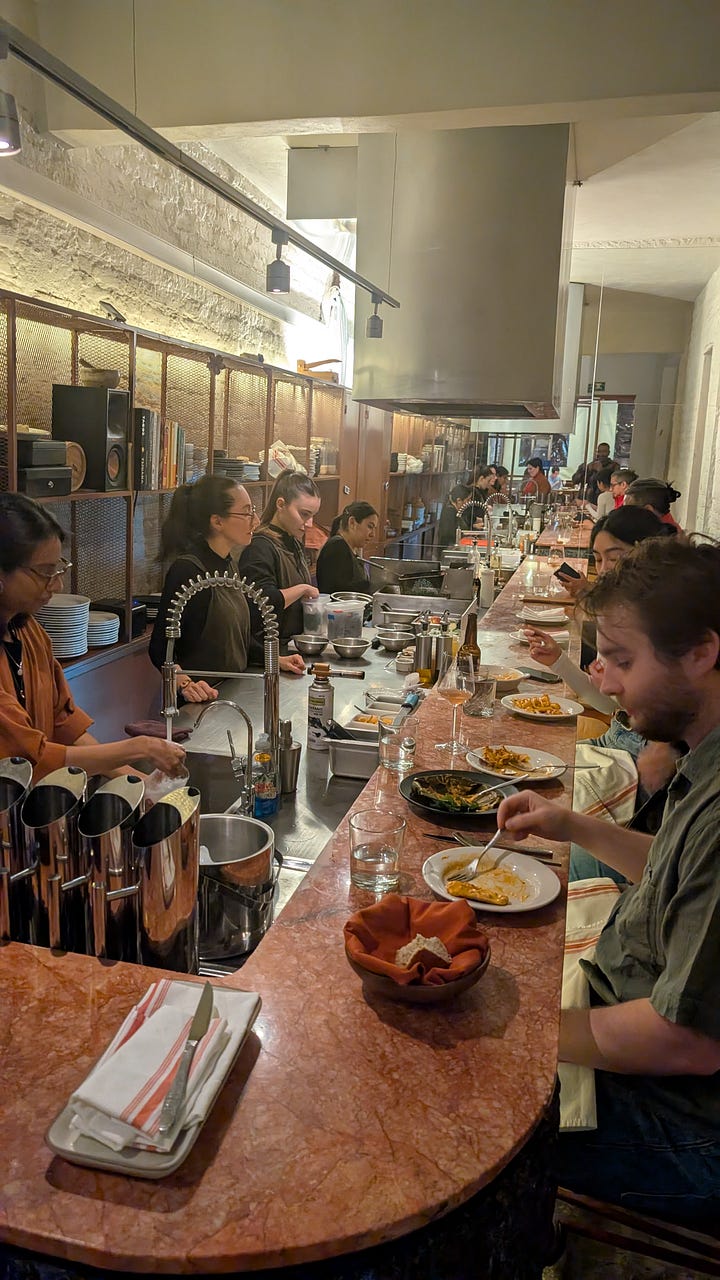 Me, enjoying a glass of wine before dinner and the kitchen-bar counter at Plonk
