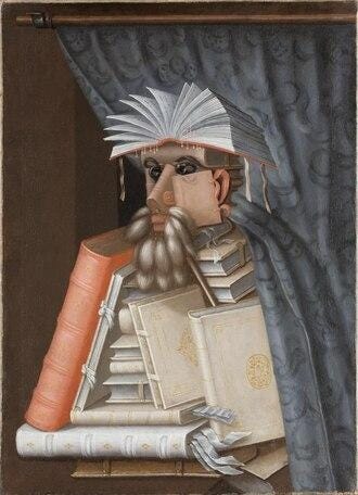 A man whose body consists of books and bookmarks passes into the foreground underneath a green curtain. A man whose body consists of books and bookmarks passes into the foreground underneath a green curtain.