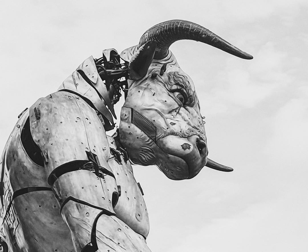 a black and white photo of a statue of a demon a black and white photo of a statue of a demon