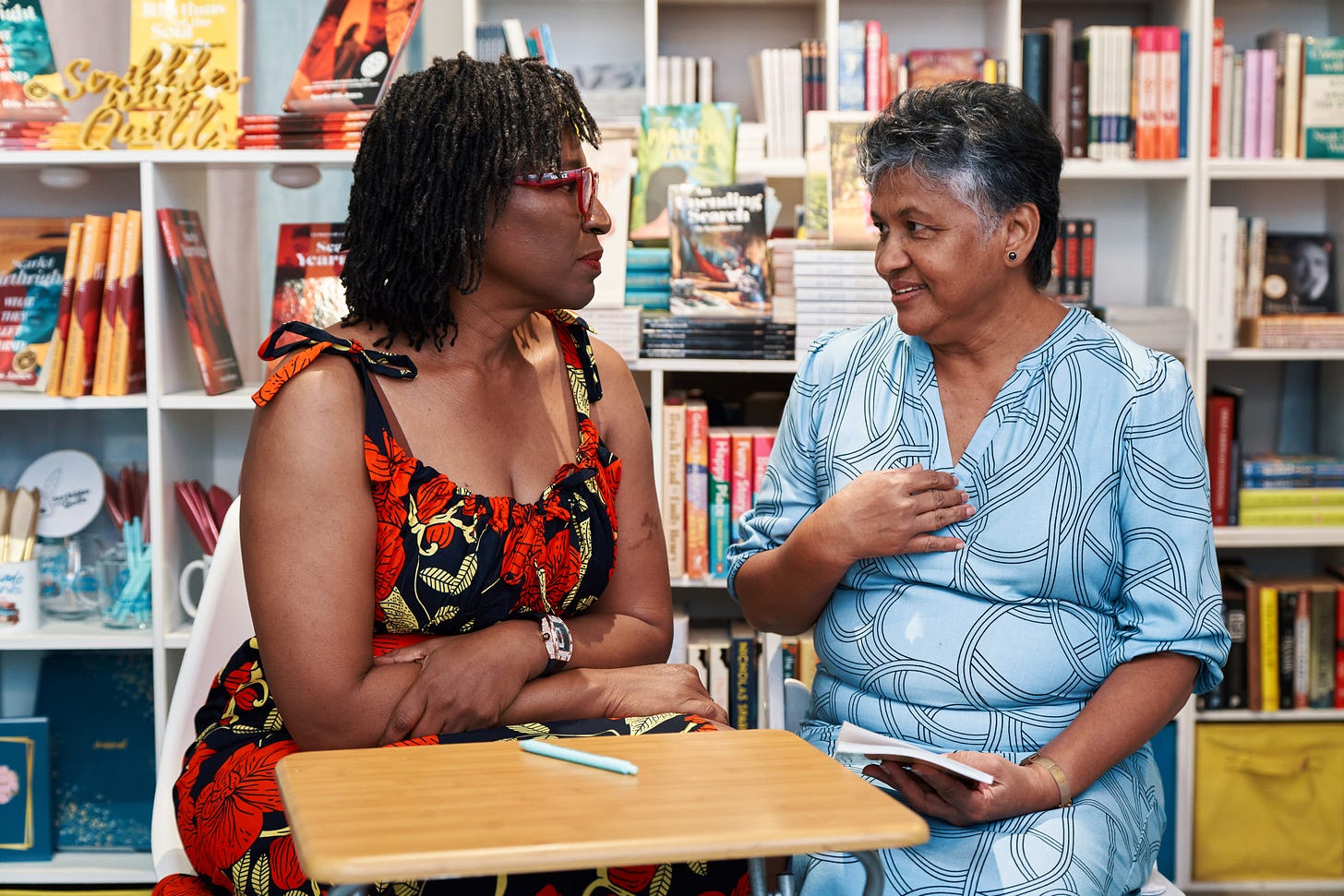 Scarlet Ibis James in conversation with one of her readers, in a bookshop.