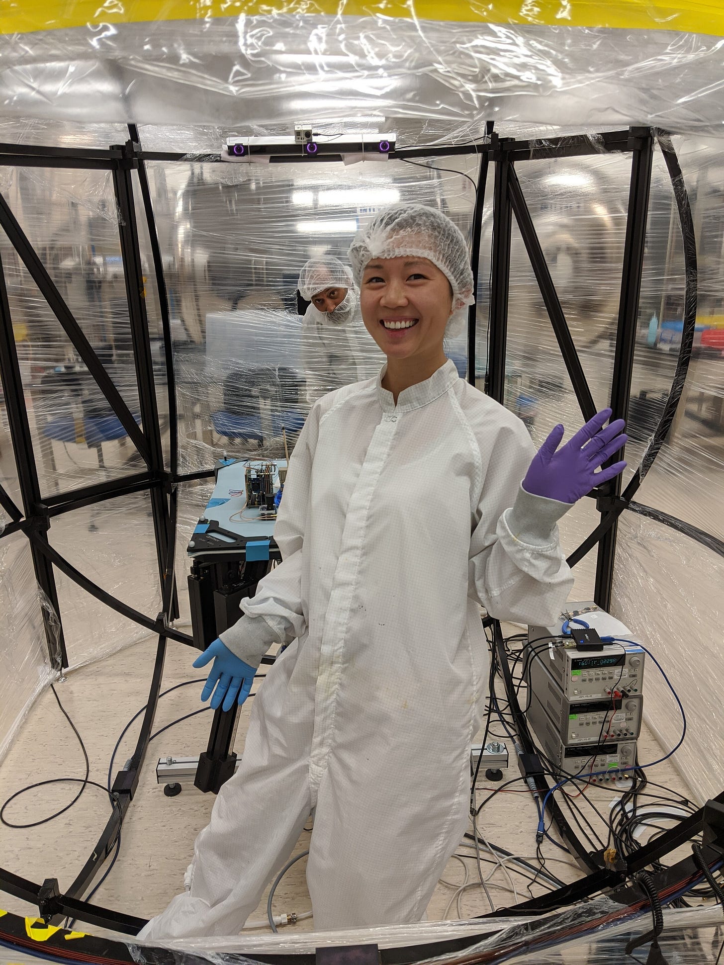 Look at this cute face. This is me at the Hawai’i Space Flight Lab’s clean room with the lovely Mr. Lloyd French behind me, peeking through the testbed shield. Do these things so more people like me can stay in spaces like this.