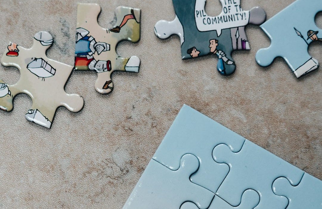 white jigsaw puzzle pieces on brown marble table white jigsaw puzzle pieces on brown marble table
