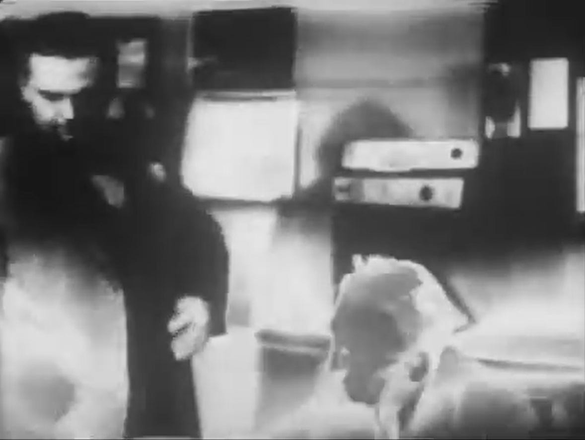 A screengrab from The Quatermass Experiment showing Paul Whitsun-Jones as well-dressed journalist James Fullalove and Oliver Johnston as newspaper editor Jacko in the editor’s office; the bottom part of the picture has turned negative A screengrab from The Quatermass Experiment showing Paul Whitsun-Jones as well-dressed journalist James Fullalove and Oliver Johnston as newspaper editor Jacko in the editor’s office; the bottom part of the picture has turned negative