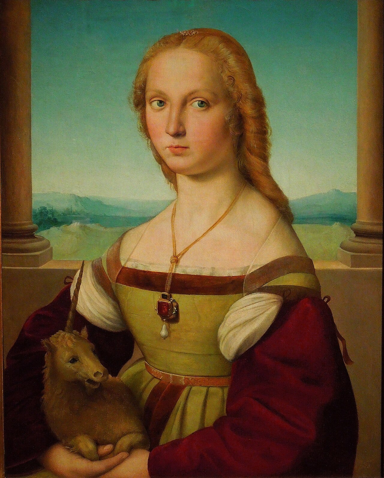 Young woman holding a small white unicorn in her lap Young woman holding a small white unicorn in her lap