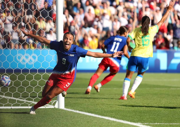 Mallory Swanson of Team United States celebrates scoring her team's first goal during the Women's Gold Medal match between Brazil and United States... Mallory Swanson of Team United States celebrates scoring her team's first goal during the Women's Gold Medal match between Brazil and United States...