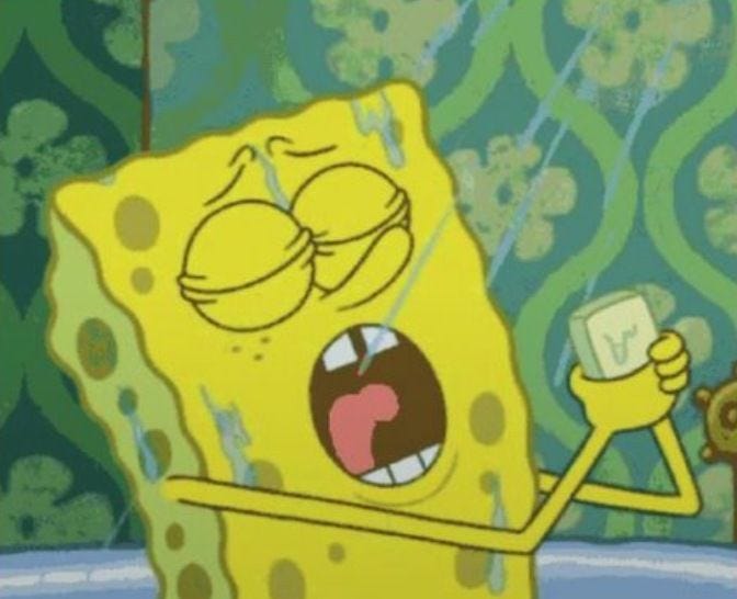 This may contain: spongebob holding up a cell phone in front of a wallpapered background This may contain: spongebob holding up a cell phone in front of a wallpapered background