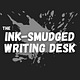 the ink-smudged writing desk
