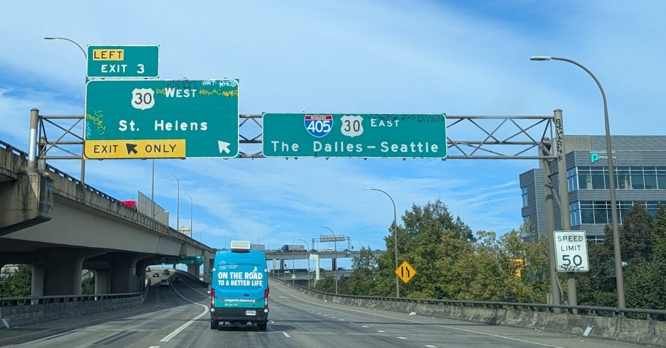 graffiti on I-405 road signs in Portland