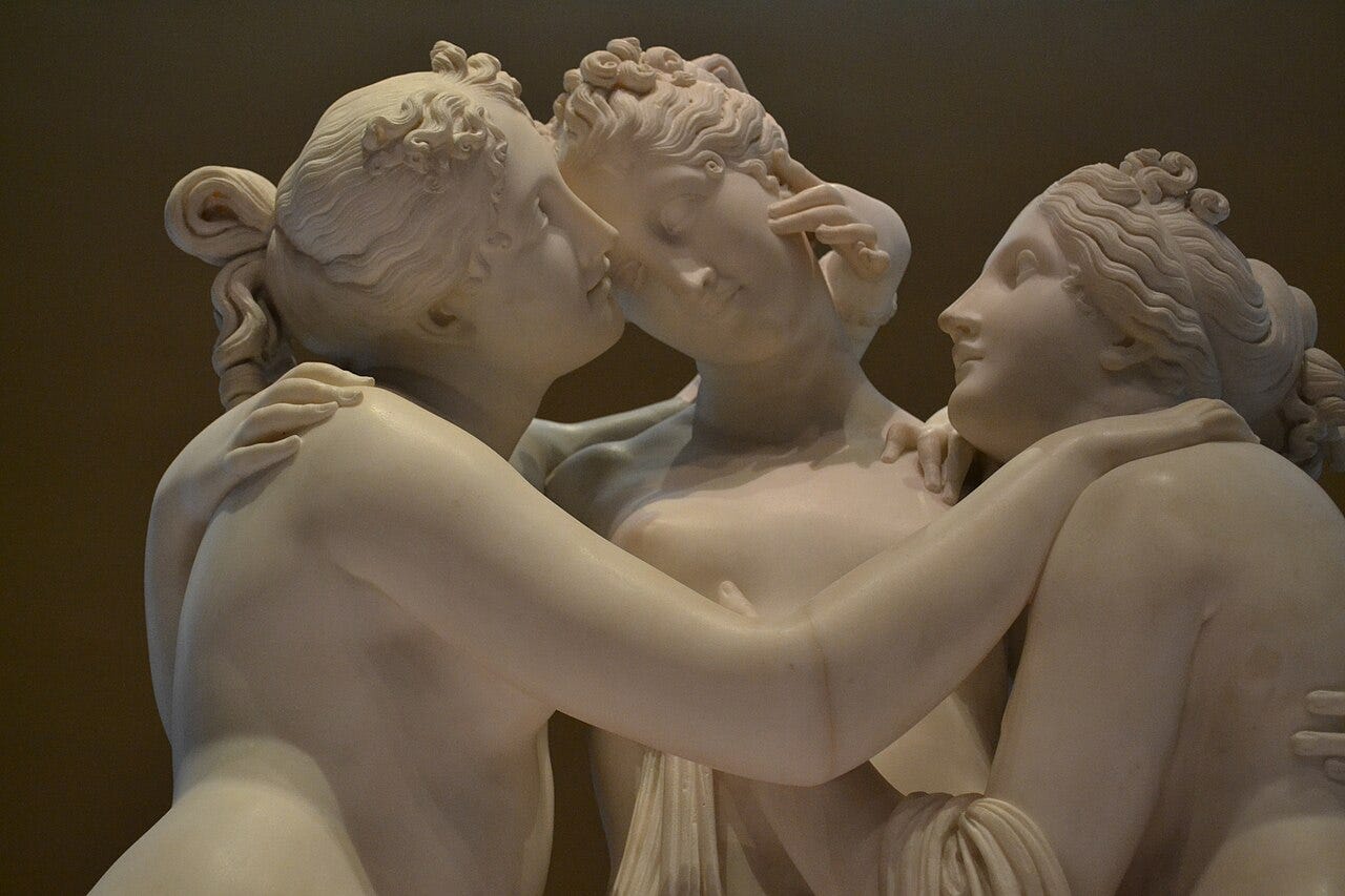 Three embracing marble goddesses