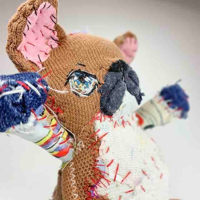 Bulldog soft sculpture looking up at the sky with arms up high symbolising victory