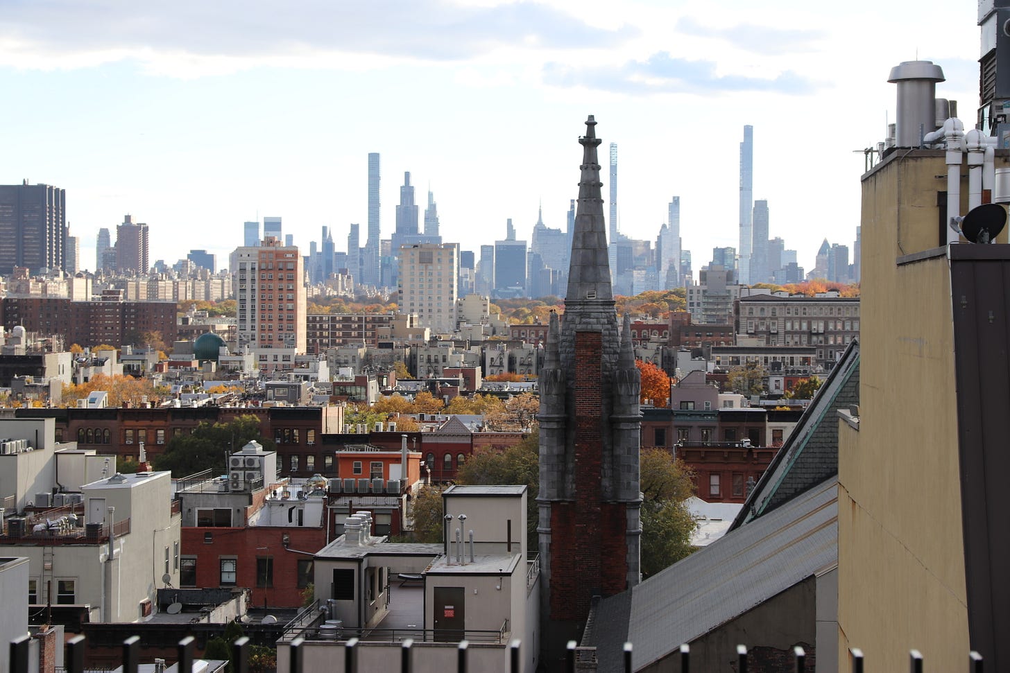 Manhattan skyline seen framed by gothic spires of churches