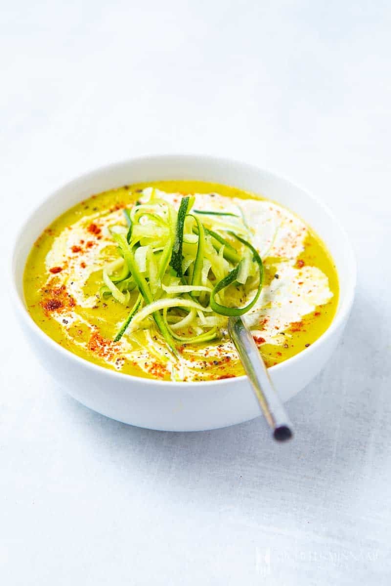 A bowl of bright green zucchini and leek soup
