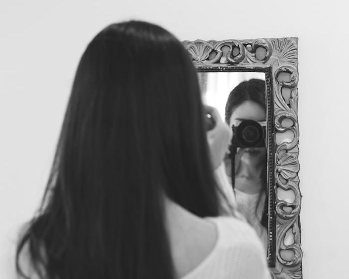 woman in white shirt taking self portrait woman in white shirt taking self portrait