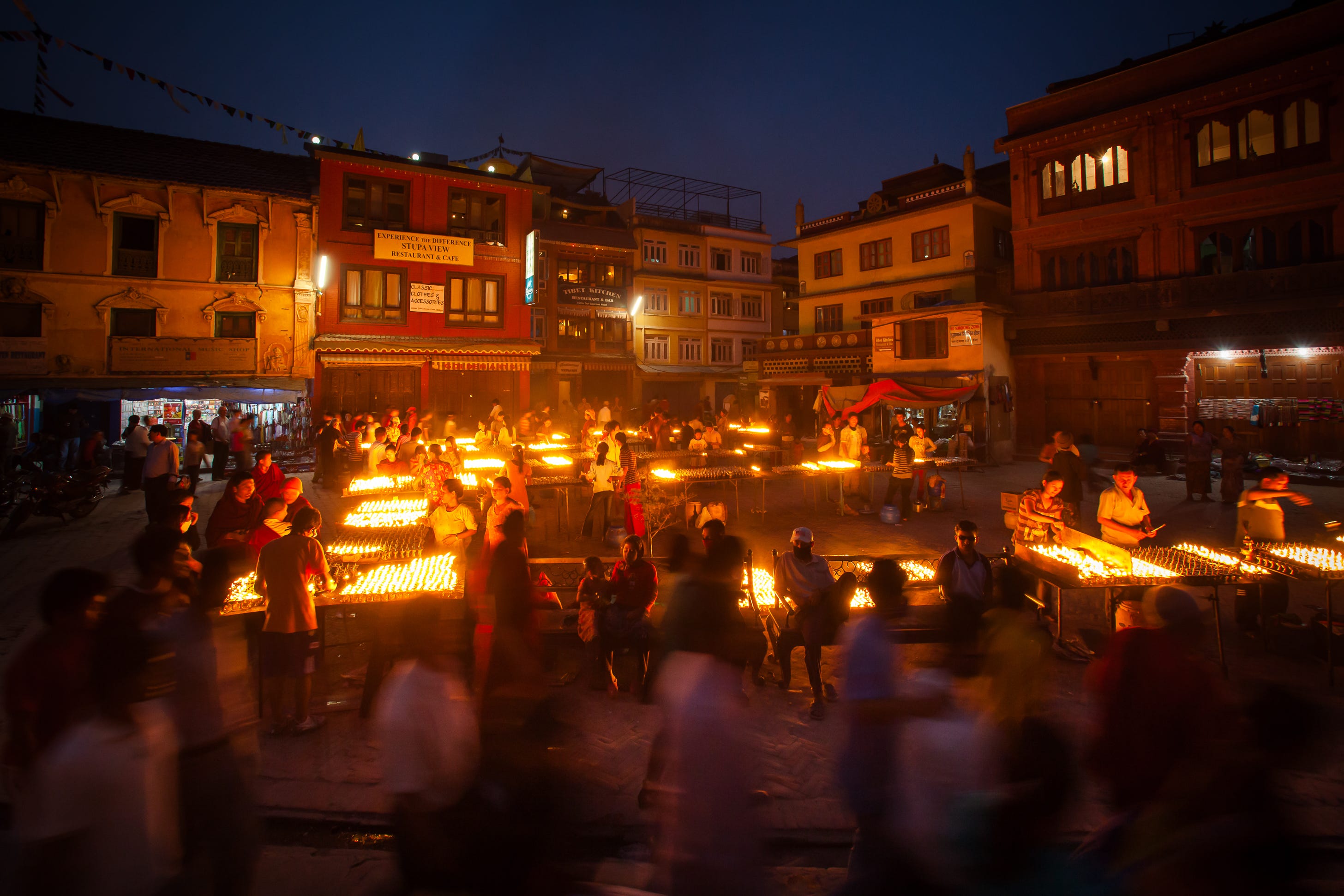 Stalls with candles for offerings, Boudha, Nepal. 1/8, ƒ8, ISO 1600, 16mm
