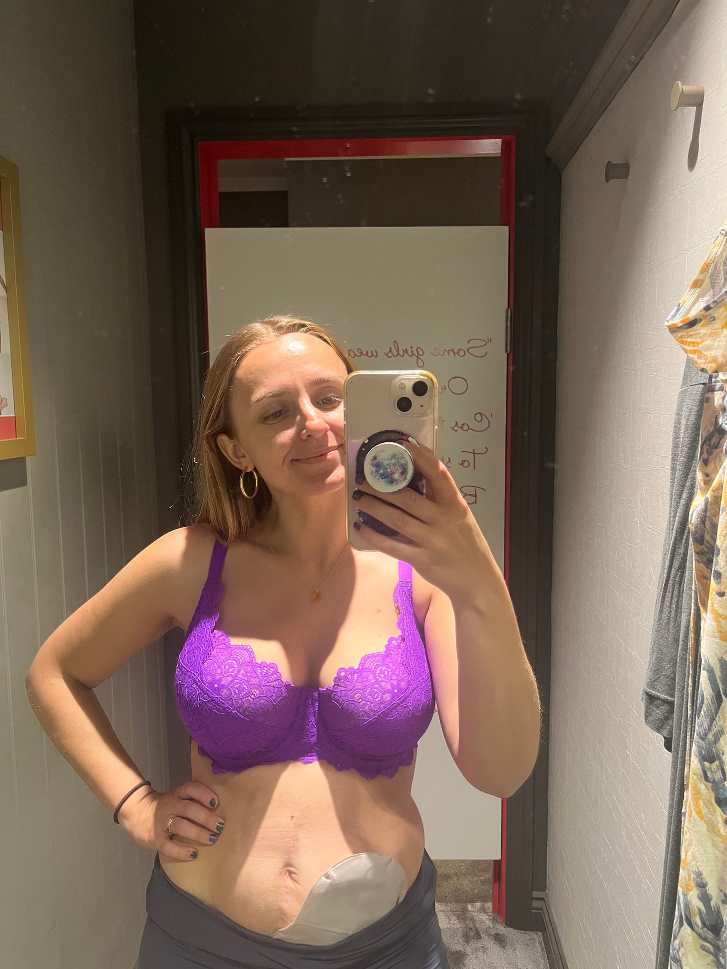 Hannah trying on the Millie Bra in purple in a changing room