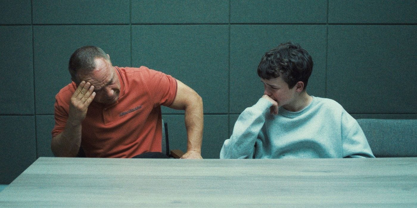 Stephen Graham as Eddie Miller and Owen Cooper as Jamie Miller sitting side by side in 'Adolescence'