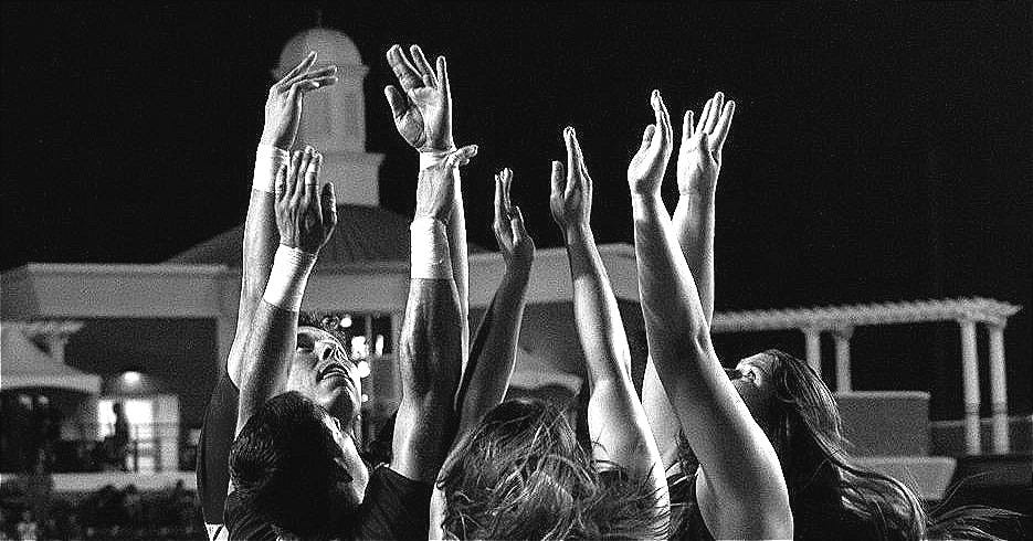 3 women in red and white shorts and sneakers jumping