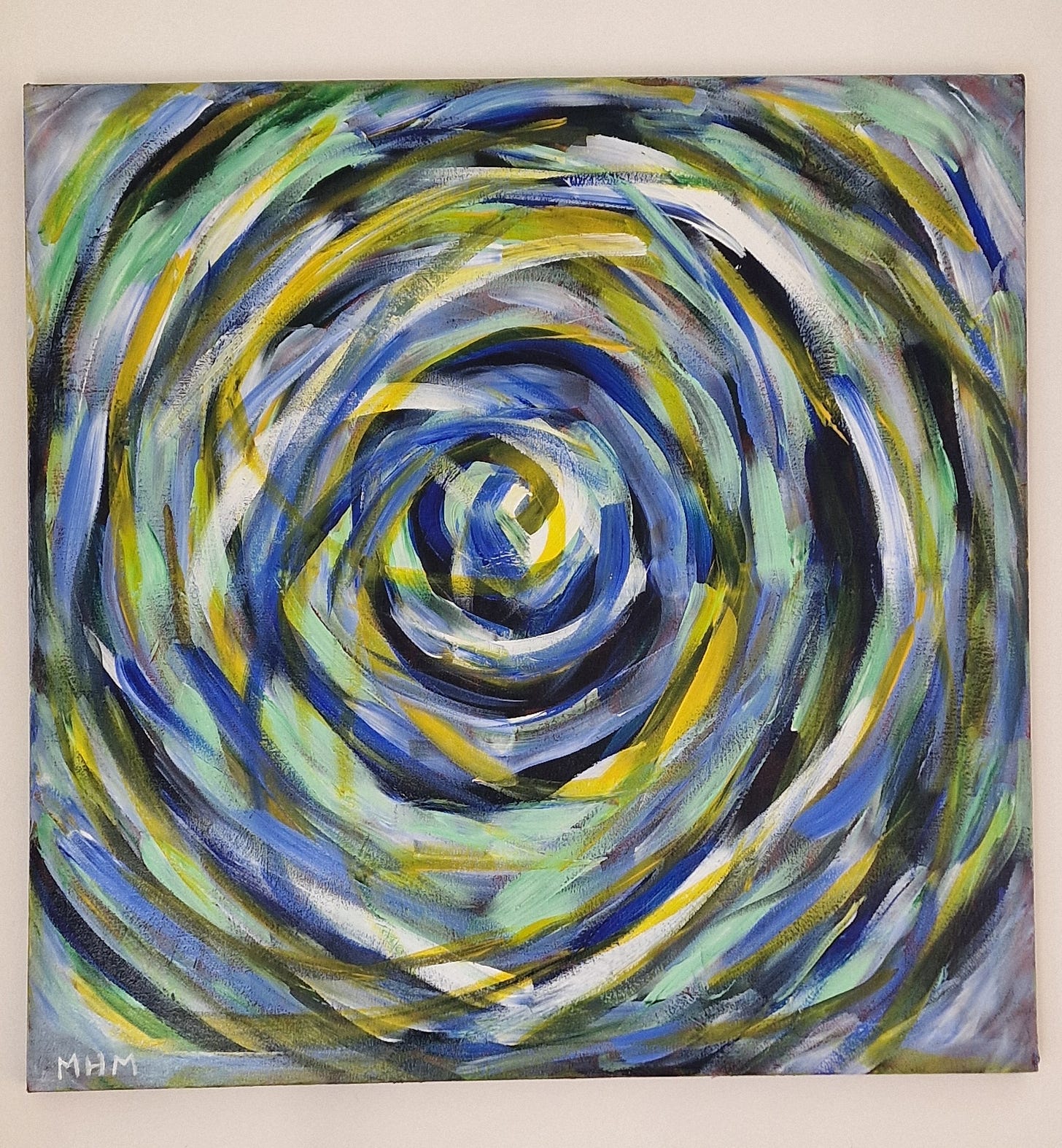 Abstract art on a square canvas (23.5"²/ 50cm²)- the main pattern is a swirl from the outer edges of the canvas to the centre. The colours interact amd merge with the dominant visible hues being aquamarine blue, sky blue, white, yellow, hooker green, light green. A hint of the burnt umber background is visible in each of the four corners under receding layers of the aforementioned colours.  Bottom left of the canvas bears my initials: MHM.