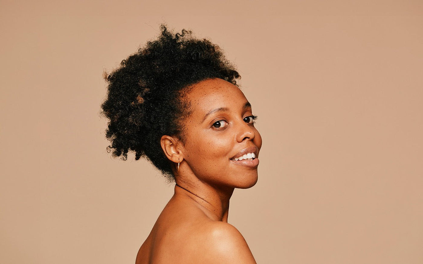 A woman unclothed smiling