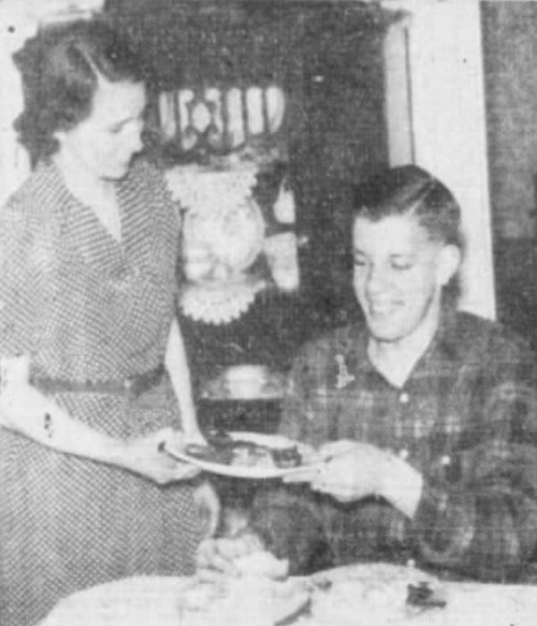 Newspaper clipping image of Naomi Nuxhall serving Joe at the family dinner table. Newspaper clipping image of Naomi Nuxhall serving Joe at the family dinner table.