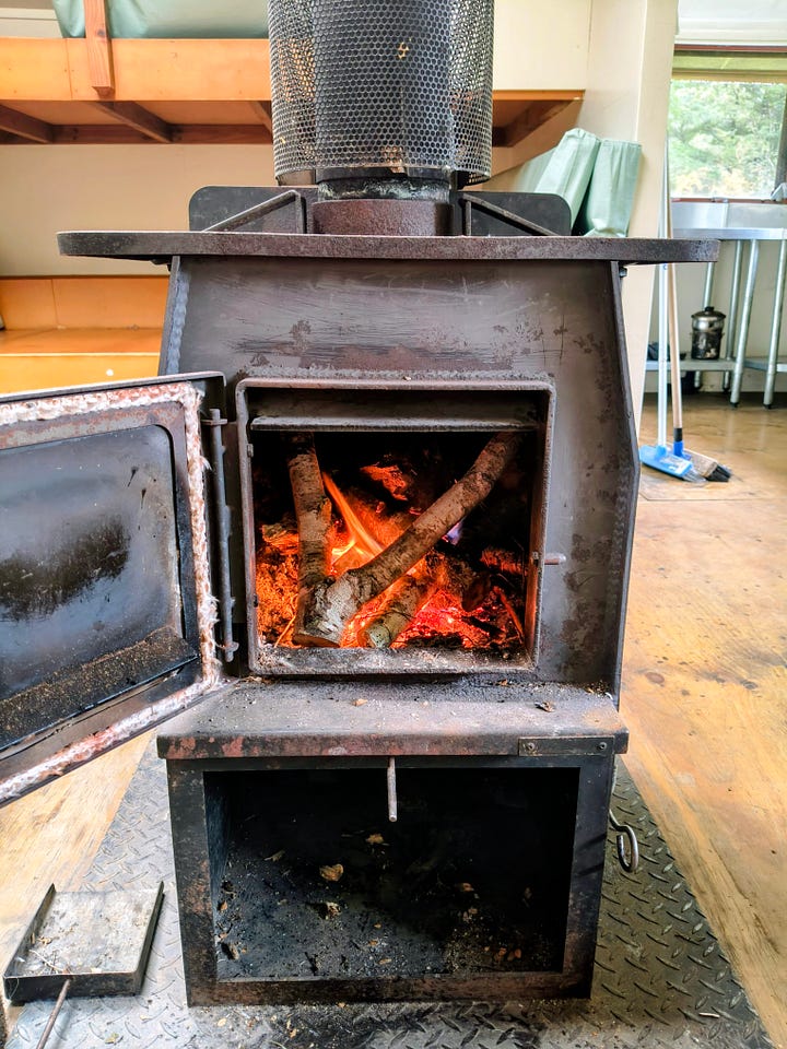 A bridge over a side creek, an orange DOC marker shows the way, Rotoroa shortly after dawn, the wood burner during a lit period at West Sabine Hut