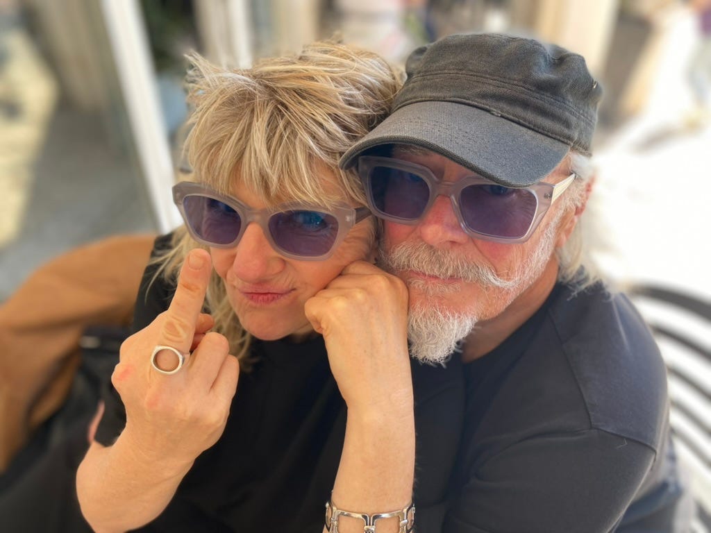 Woman and a man wesring sunglasses and a hat