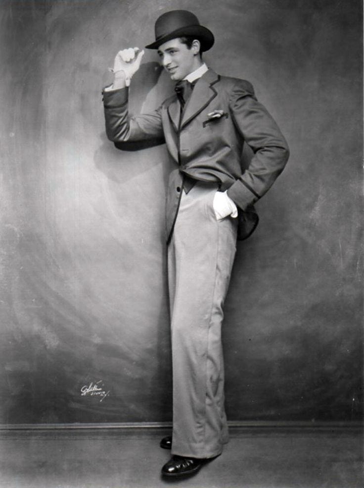 This may contain: an old photo of a man in a suit and top hat posing for the camera This may contain: an old photo of a man in a suit and top hat posing for the camera