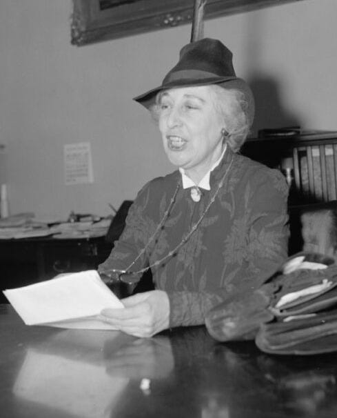 <em>First woman congress member protests increase in nation's armed forces. Washington, D.C., Feb. 7. Jeanette Rankin, first woman member of Congress, told the Naval Affairs Committee for the House today that there is 'much technical opinion within the Navy Department against the fortification of Guam as there is for it', and that the reason that the committee had not heard such opinions is because, 'announcements of policy come only from the top.' Miss Rankin voted against U.S. entrance into the World War, 2-7- 39. </em>Photo by Harris & Ewing, 1939. https://www.loc.gov/pictures/resource/hec.26014/
