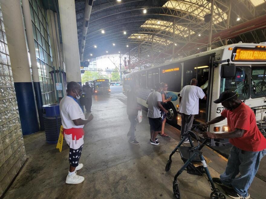 Passengers waiting to board a bus
