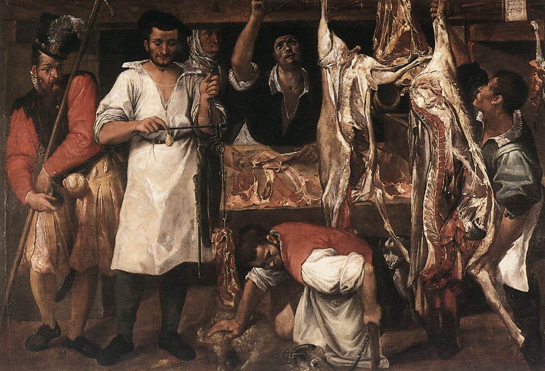 Butchers weigh and cut meat as carcasses hang around a busy shop Butchers weigh and cut meat as carcasses hang around a busy shop