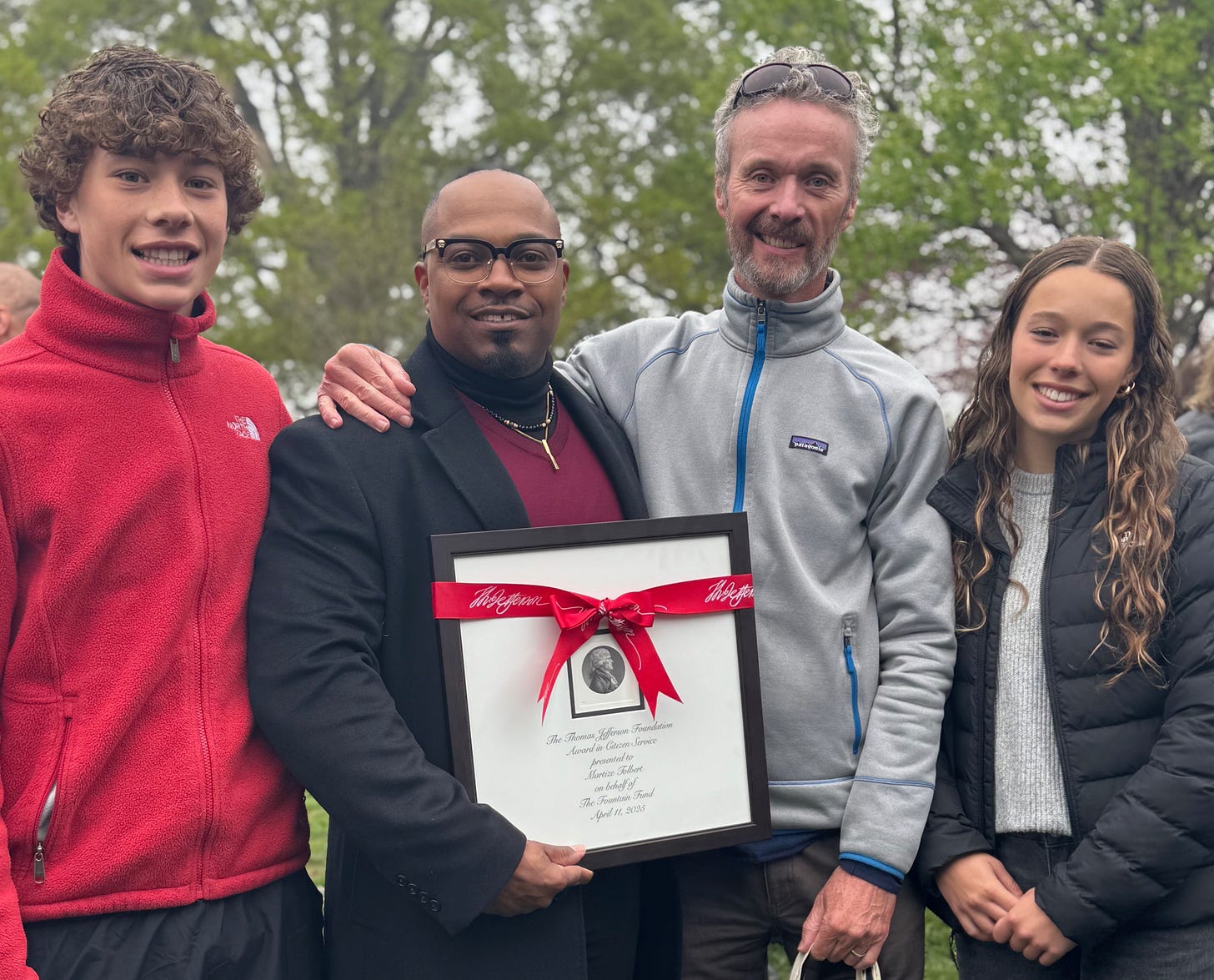 Photo of Liam, Tez (and his award certificate), me, and Nora