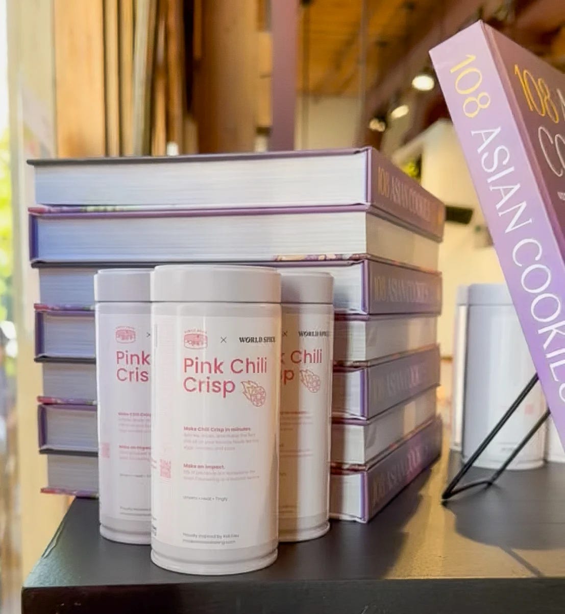 Tins of Pink Chili Crisp and cookbooks