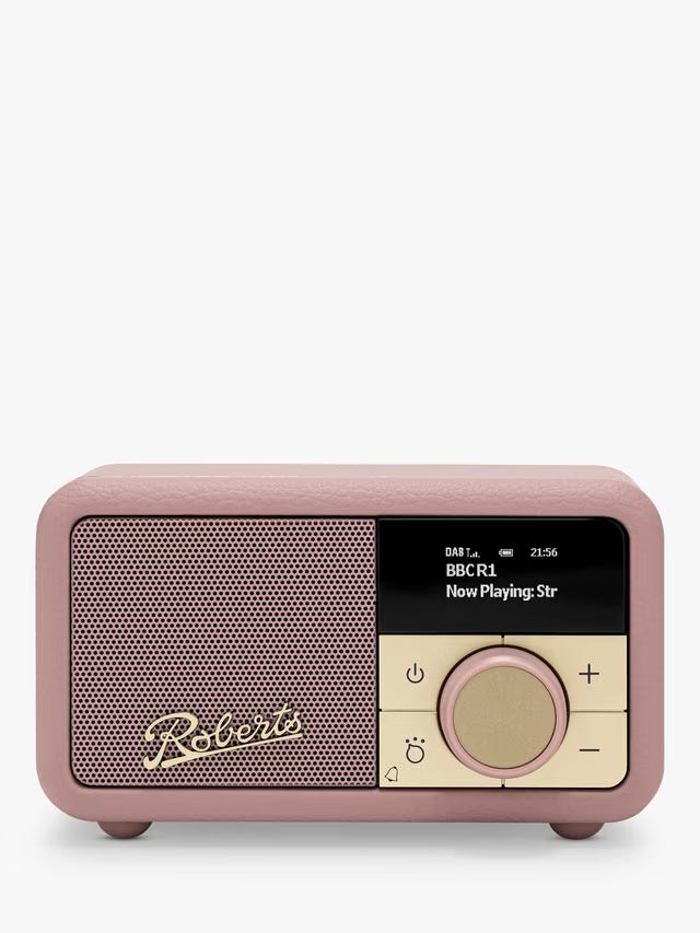 a wool banket, delft tile, pink radio and bed with brass lamp
