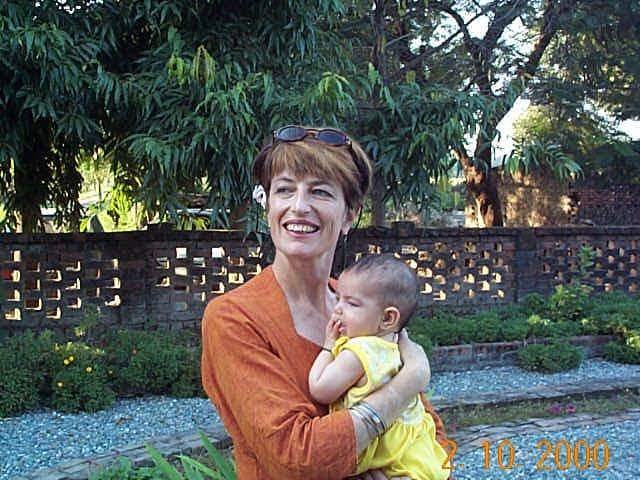 A middle-aged woman holds a young baby on 02/10/2000 A middle-aged woman holds a young baby on 02/10/2000