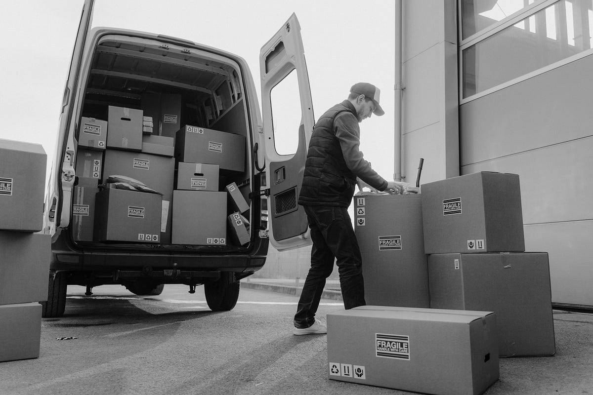 delivery driver loading delivery truck with packages delivery driver loading delivery truck with packages