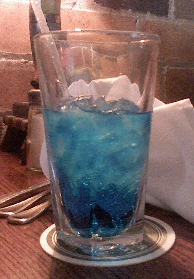 A glass of electric blue cream soda