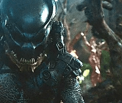A scary alien with big teeth dressed in armor.