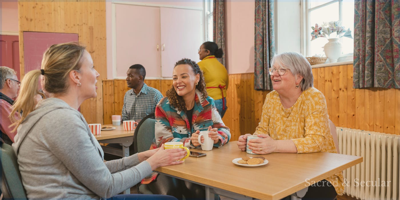 People talking together in a community hall over tea and coffee, illustrating themes of belonging, friendship, loneliness, community, faith, and the importance of shared rituals in modern life. People talking together in a community hall over tea and coffee, illustrating themes of belonging, friendship, loneliness, community, faith, and the importance of shared rituals in modern life.
