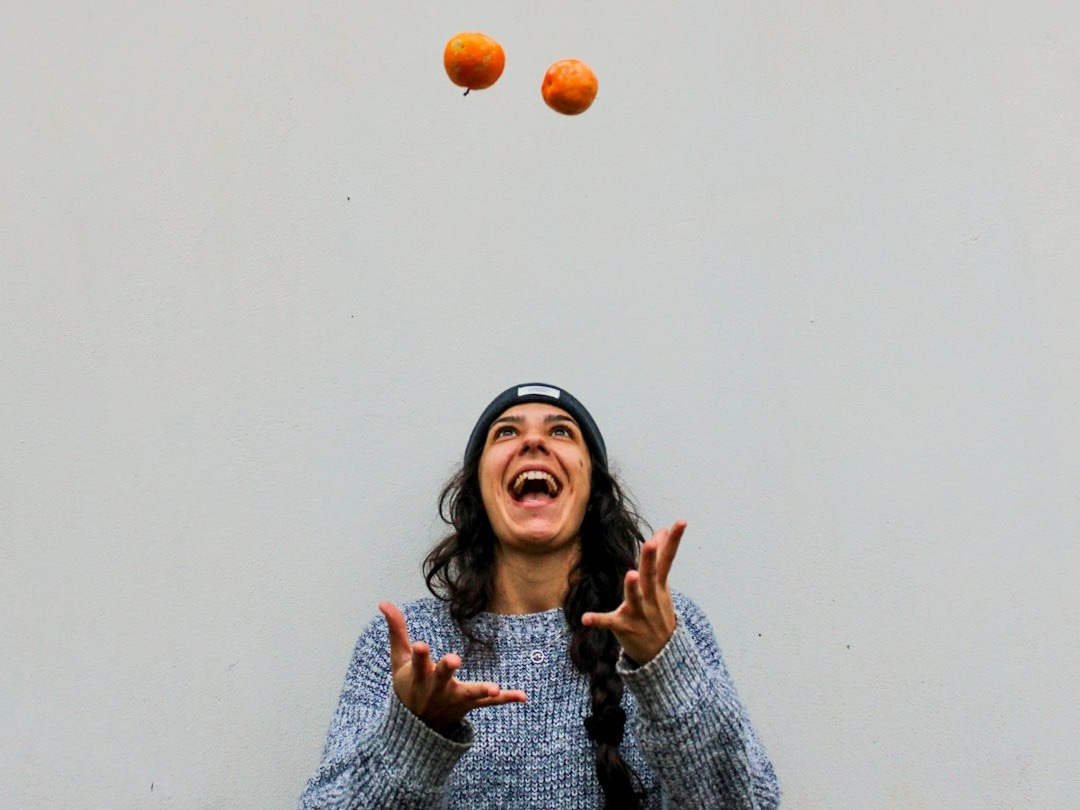 woman in gray sweater smiling woman in gray sweater smiling